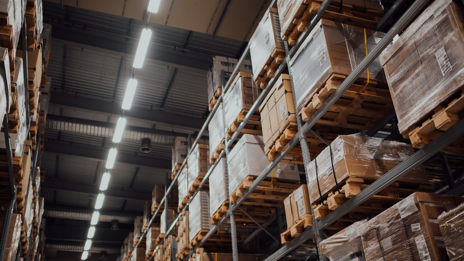 Cardboard cartons stacked on a warehouse rack, ready to be packed and weighed for export.